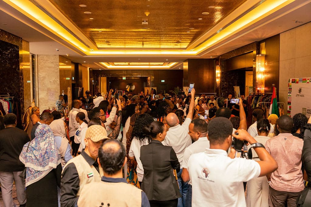 A packed crowd captures the moment on their phones