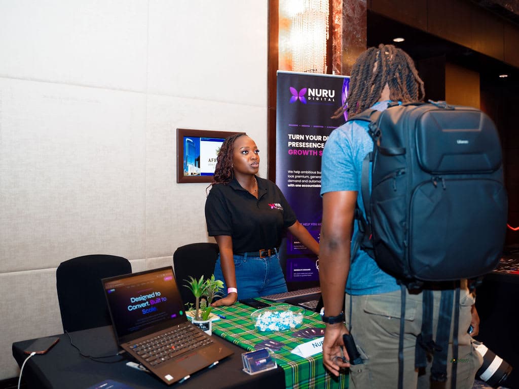 The Nuru Digital team engaging with a visitor at their stand
